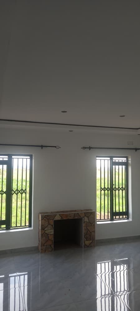 The lounge with a stone-clad fireplace and polished tiles