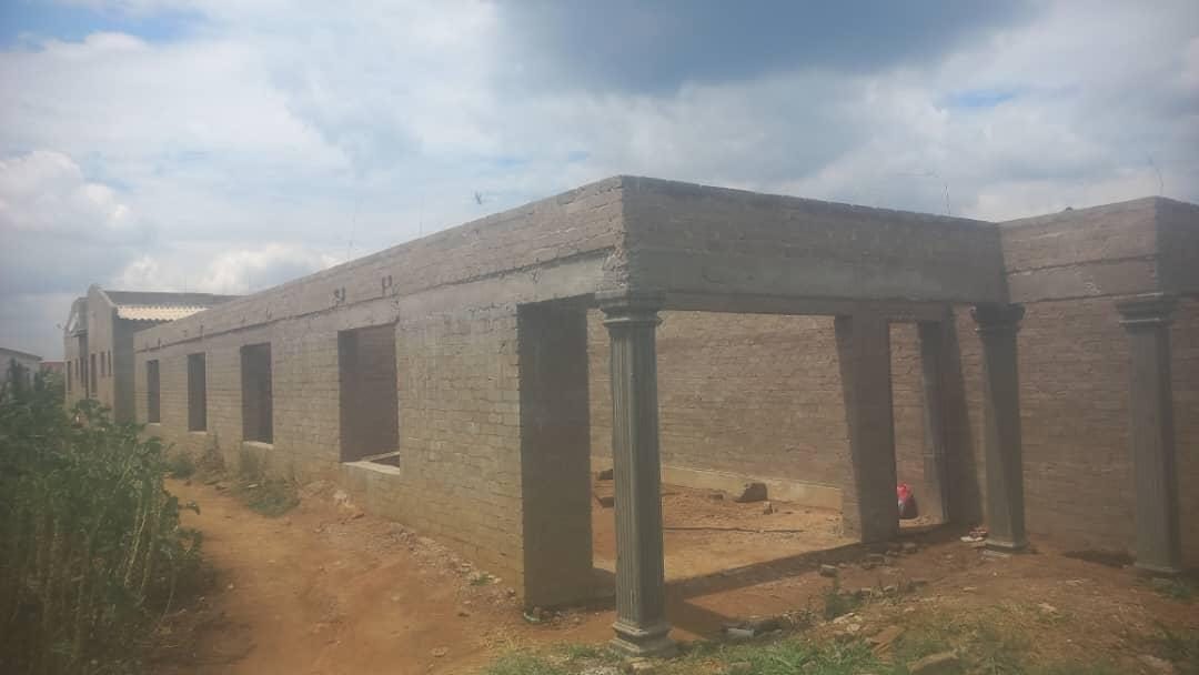Before: the brick walls at wall plate, ready for the roof