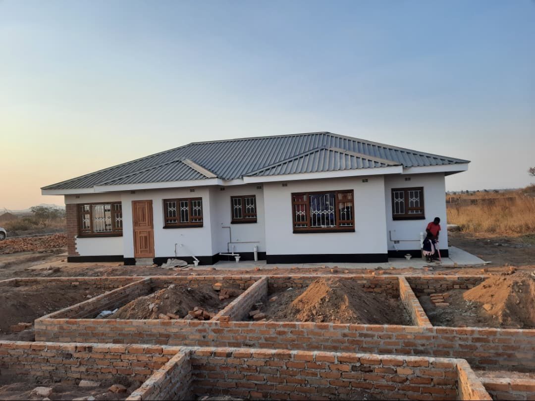 The painted side of the house with the next foundation in front